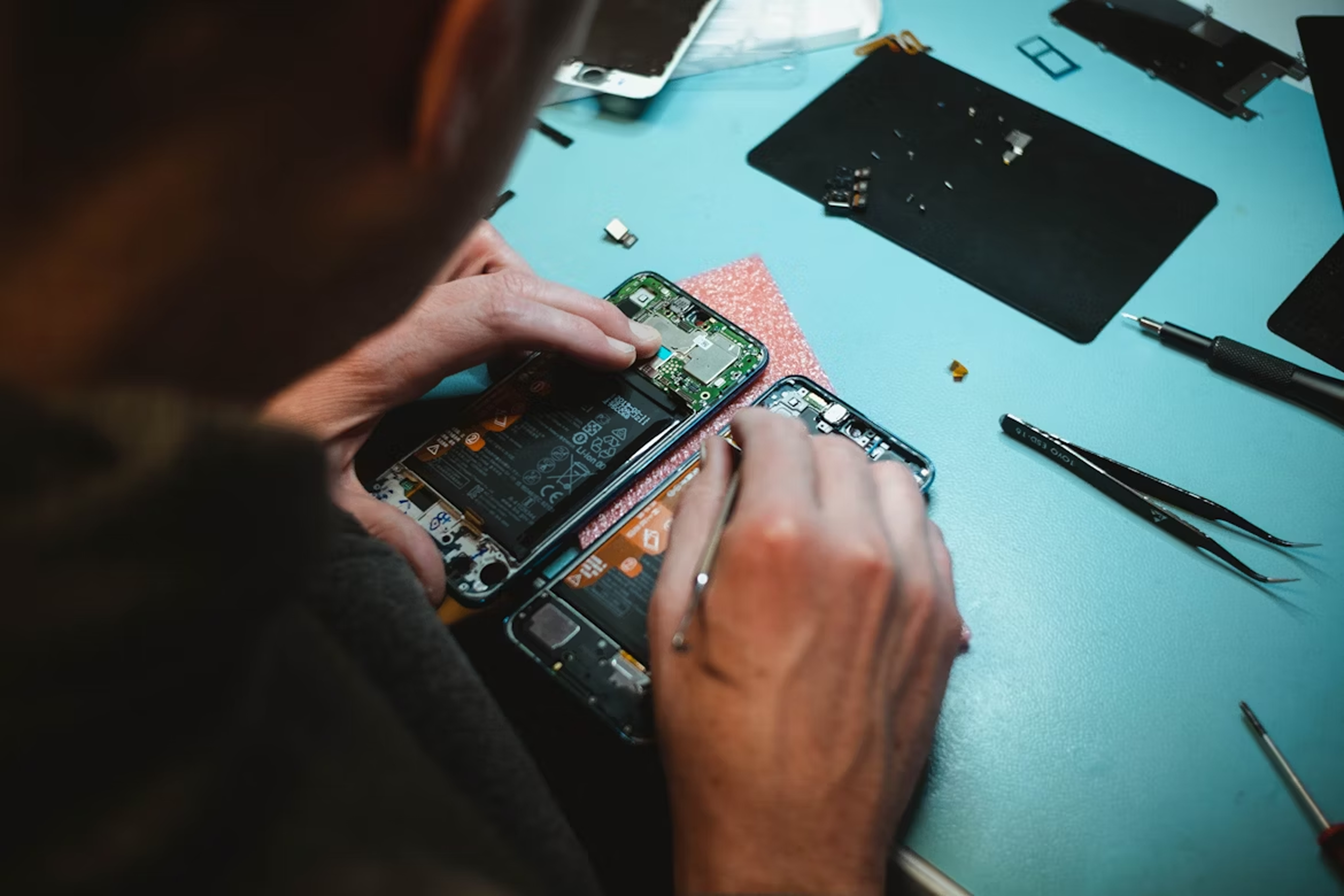 Technician repairing a smartphone